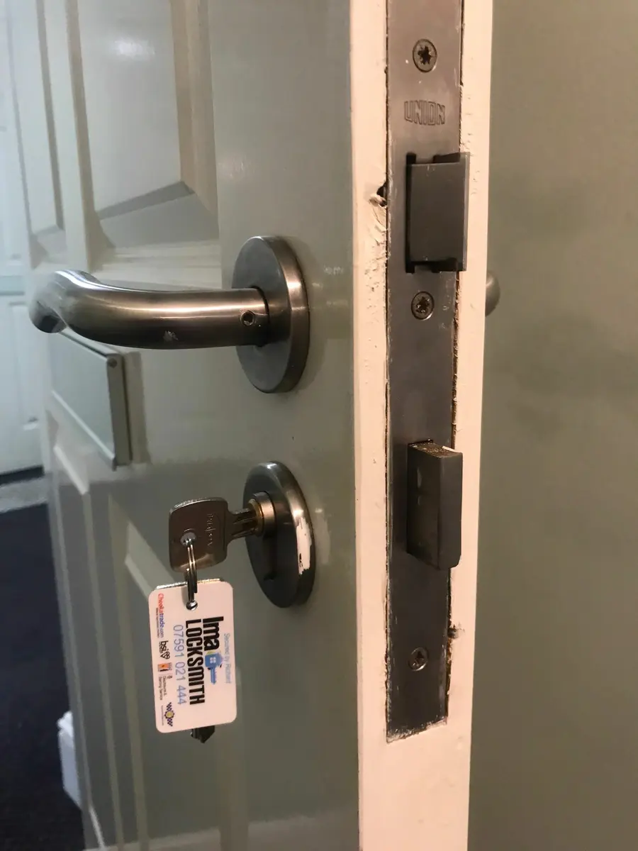 Union mortice sash lock and stainless lever handle fitted to a grey panelled door, IMA Locksmith tag on the key