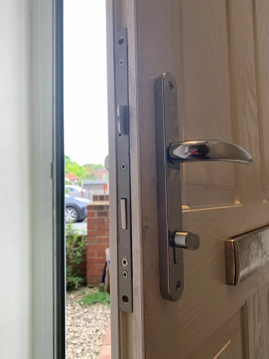 Chrome multipoint handle and thumb turn cylinder fitted to a cream composite front door