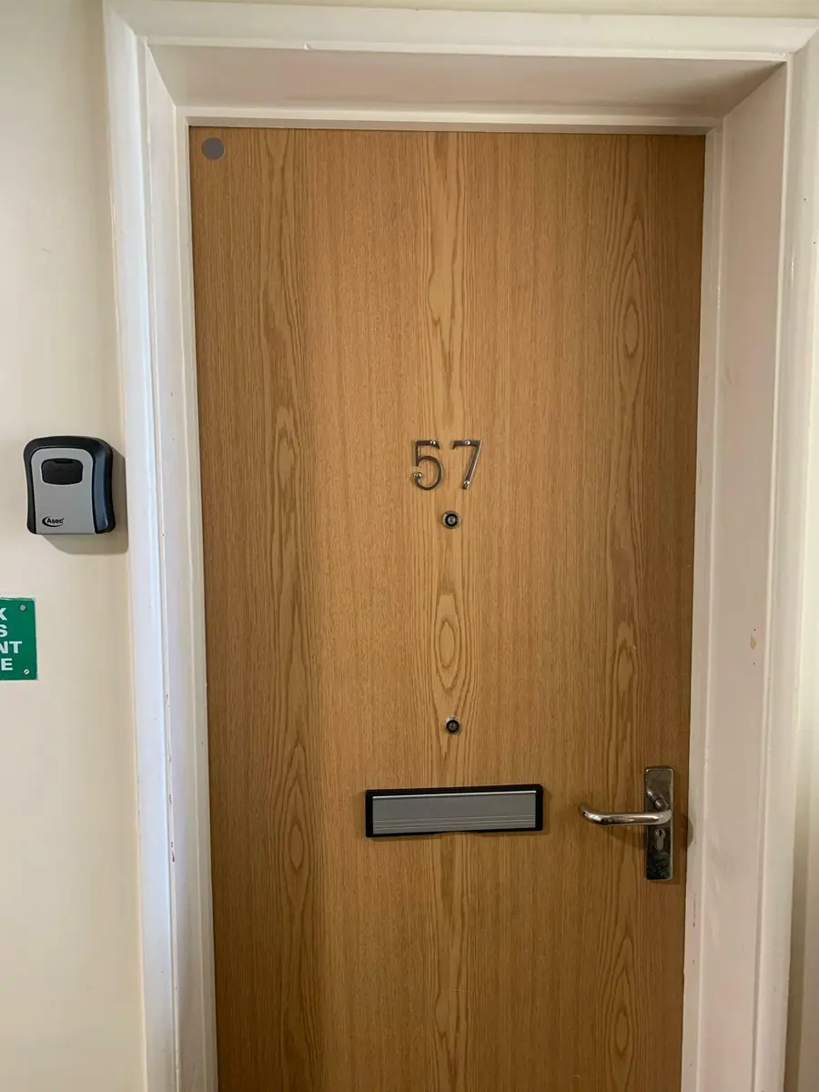 Flat entrance door with new lever handle, euro cylinder and wall mounted Asec key safe