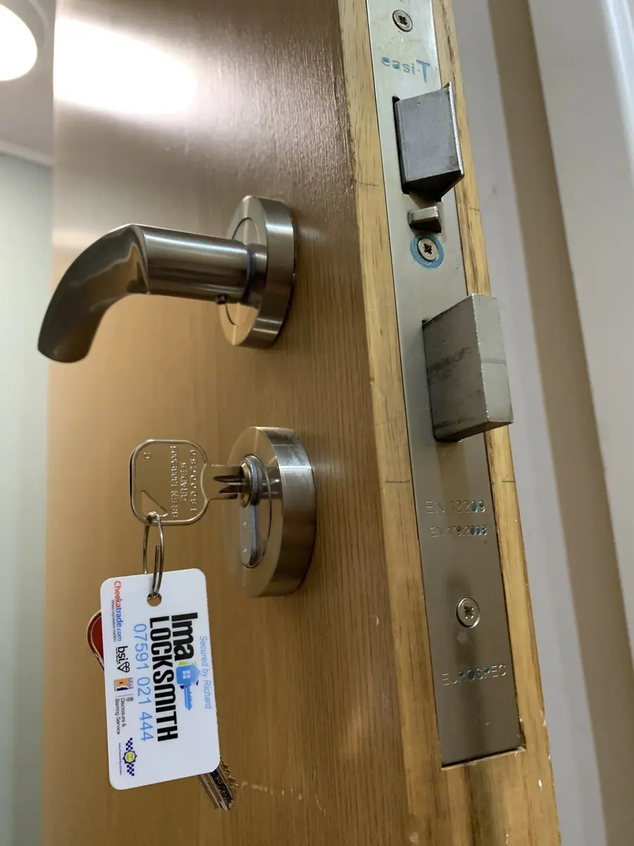 Eurospec easi-T mortice lock and stainless lever handle fitted to an oak office door, IMA Locksmith tag on the keys
