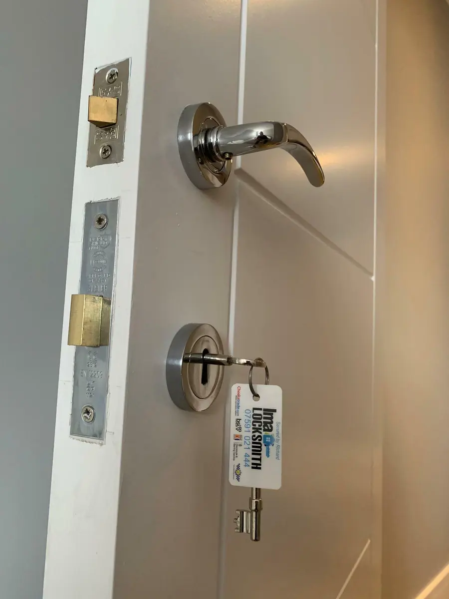 Three lever mortice deadlock and chrome lever handle fitted to a white internal door, IMA Locksmith tag on the key