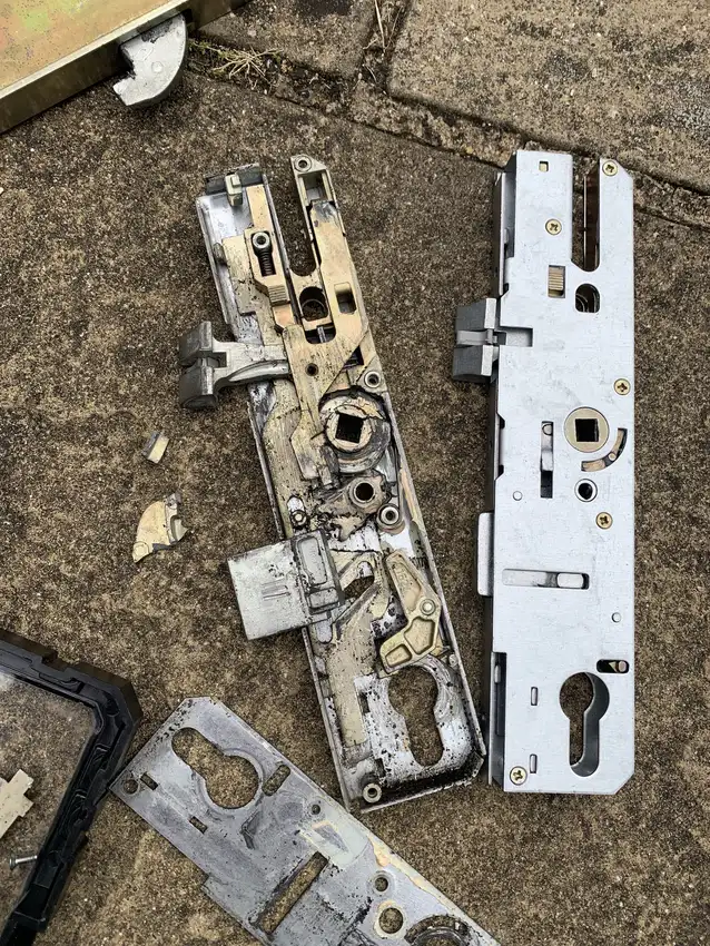 Failed uPVC multipoint gearbox stripped down beside its new replacement lock ready for fitting