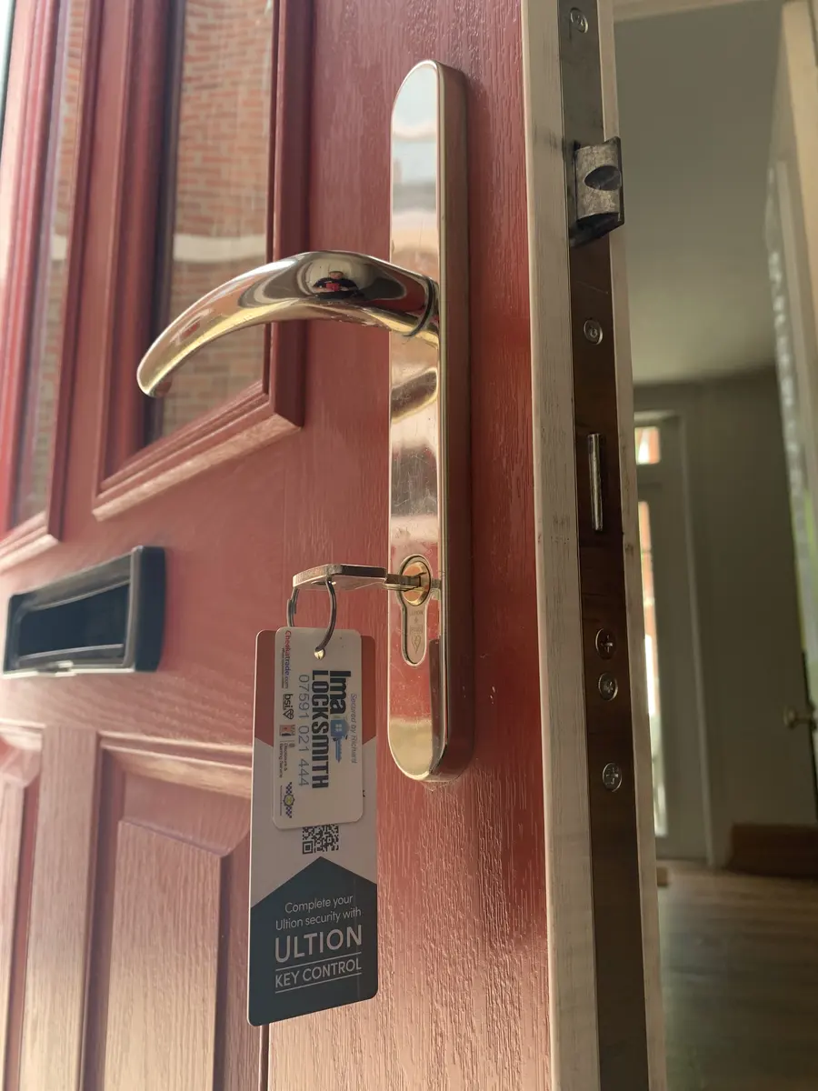 Ultion Plus anti-snap cylinder and polished brass handle on a red front door, Ima Locksmith tag on the key