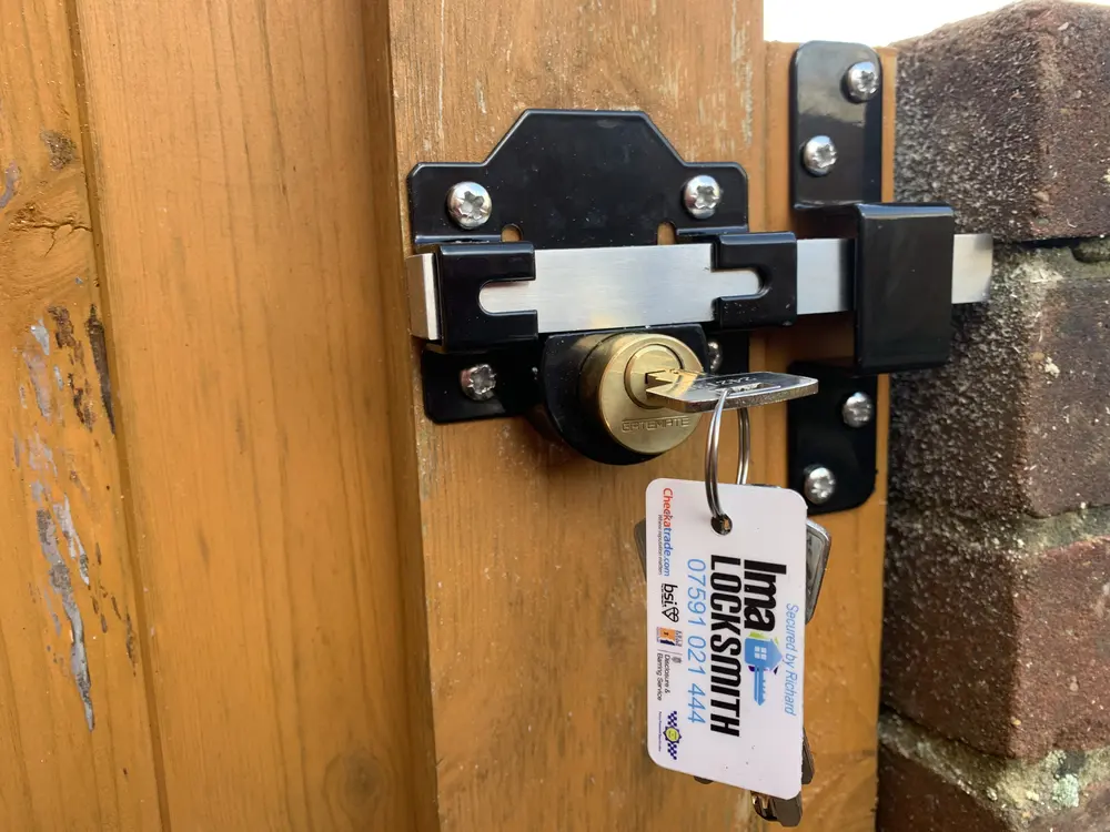 Gatemate long throw gate lock with stainless bolt fitted to a timber gate, Ima Locksmith tag on the keys