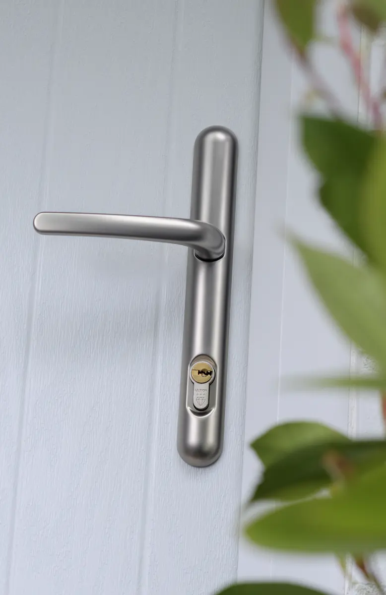 Satin chrome lever handle with Ultion three star cylinder on a pale grey composite door