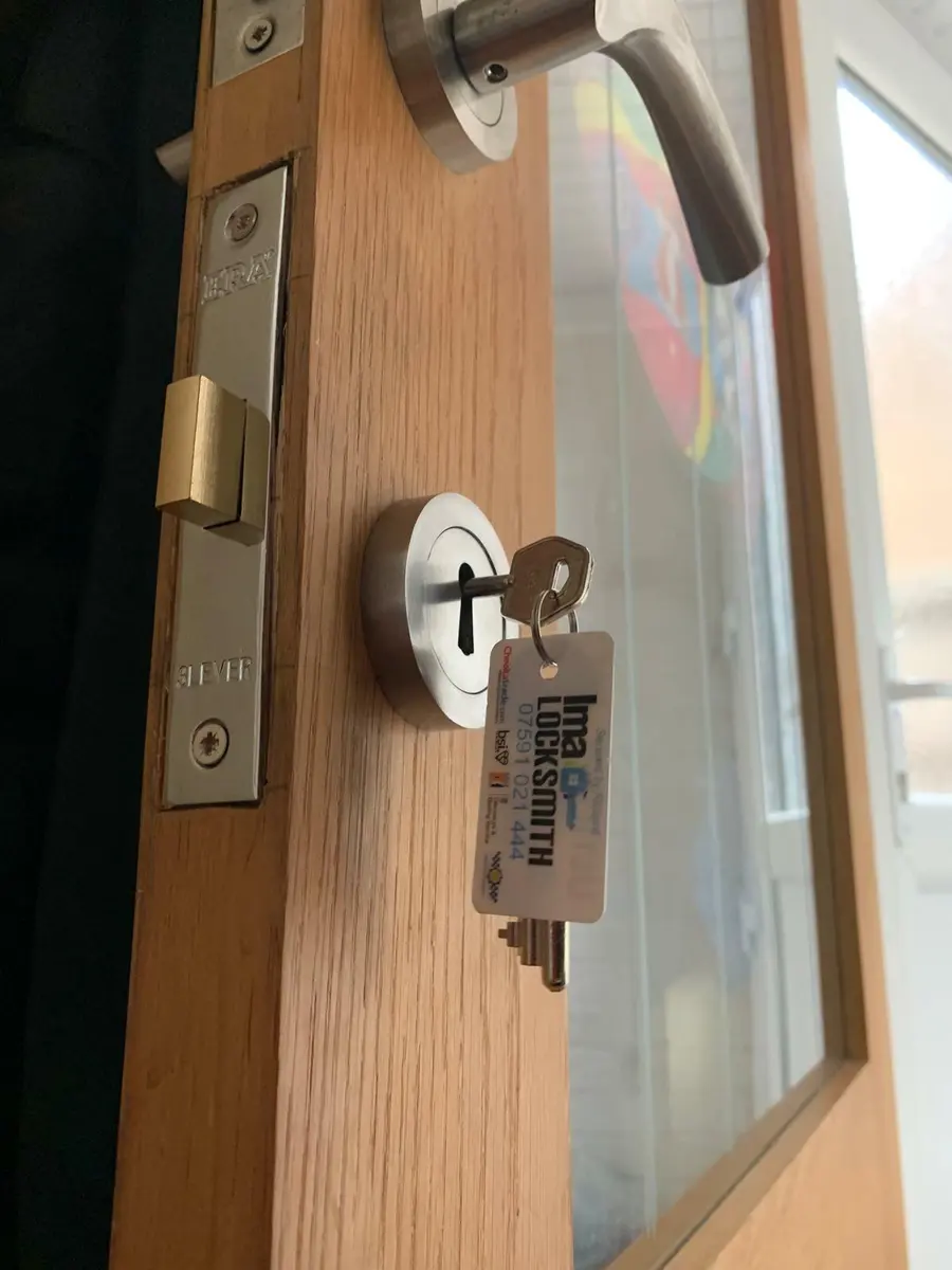 ERA three lever mortice sashlock in an oak glazed door, key and Ima Locksmith tag in the escutcheon