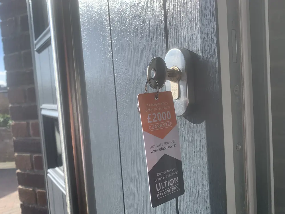 Ultion three star anti-snap euro cylinder in a grey composite door with £2000 guarantee tag
