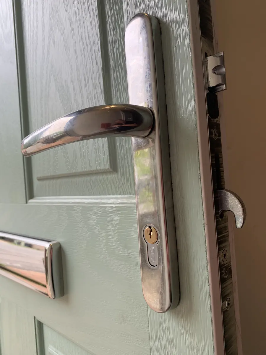 Chrome multipoint handle and hook bolt on a sage green composite door with euro cylinder