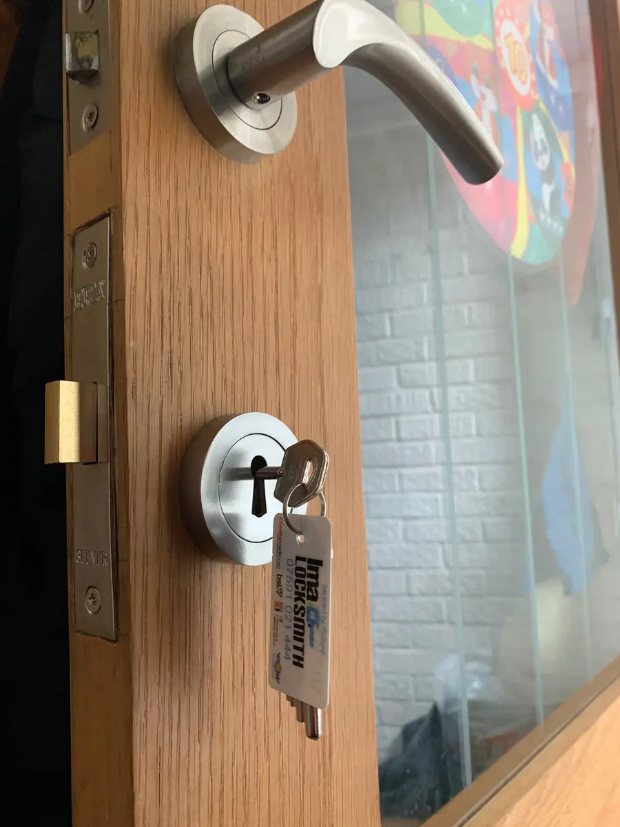 ERA three lever mortice sashlock in an oak glazed door with brushed steel handle and tag