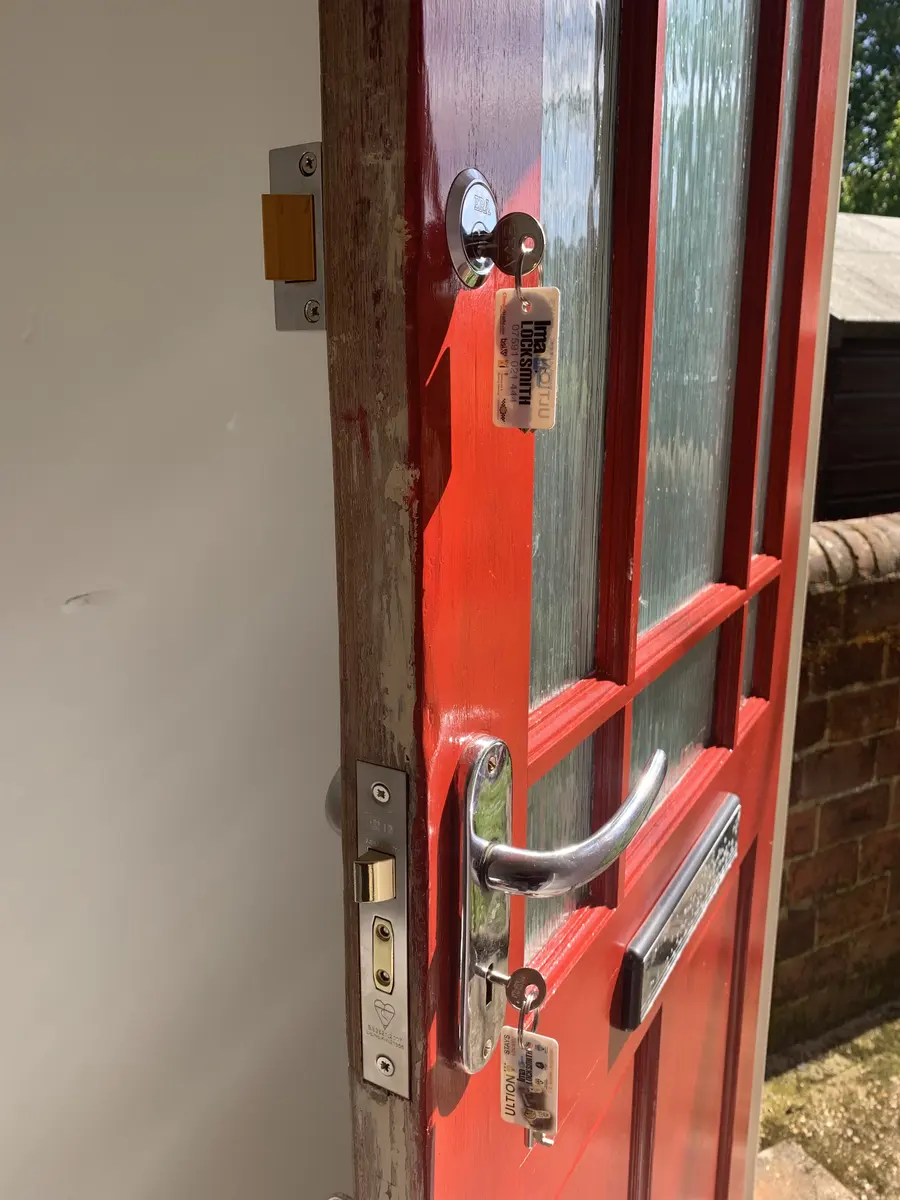 Red glazed front door fitted with a British Standard mortice sashlock and ERA deadlock, keys tagged