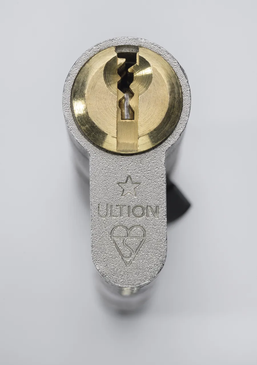 Macro photograph of an Ultion anti-snap euro cylinder showing the star-stamped keyway
